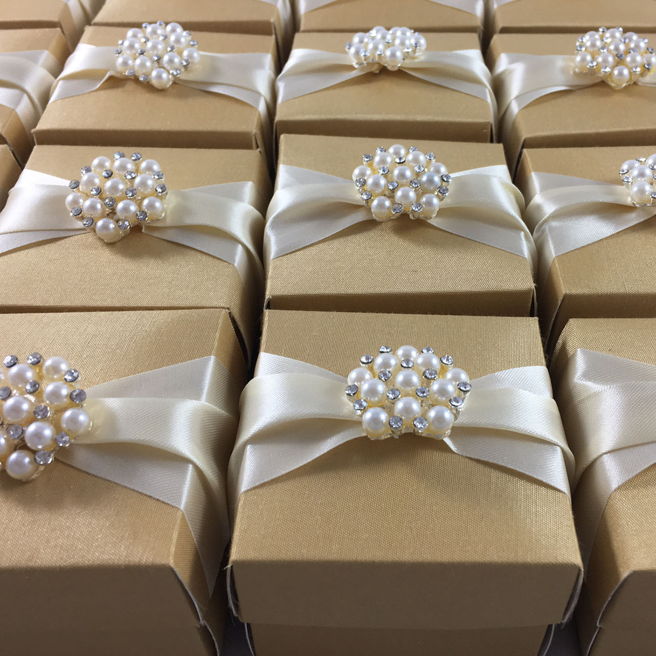 golden-wedding-favour-box-with-cream-ribbon-featuring-pearl-brooch