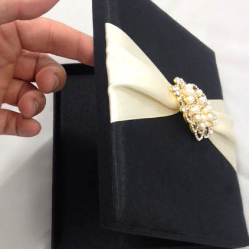 Opened silk wedding box with crown pearl brooch