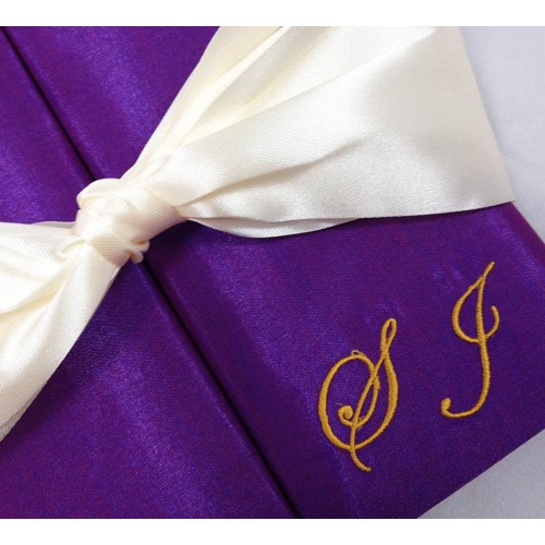 Monogram embroidery and ribbon bow on gatefold wedding invitation box