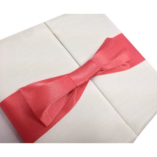 Handmade bow placed on silk folder