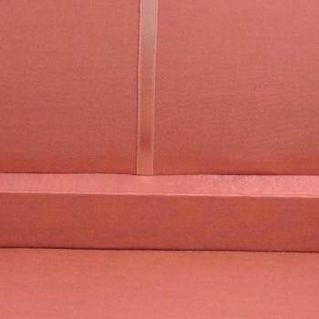 Small ribbon holder inside a dusty pink silk box