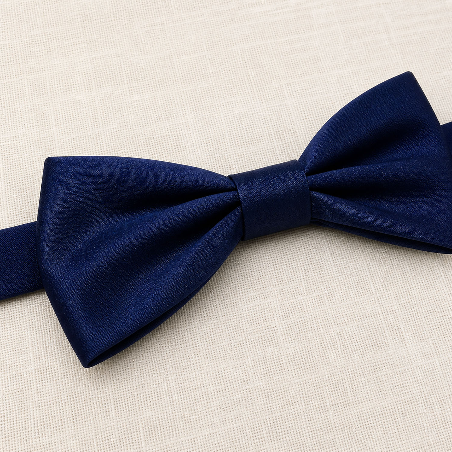 Handmade navy silk bow on natural linen
