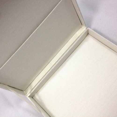 Pocket inside a silk invitation box with ivory silk