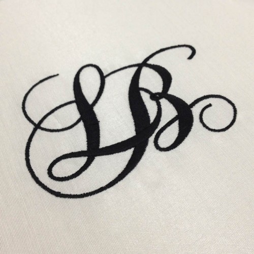 Luxury monogram embroidery in black on ivory silk folio