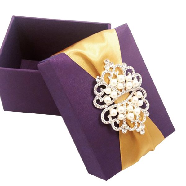 Purple silk favor box, embellished with pearl crown brooch