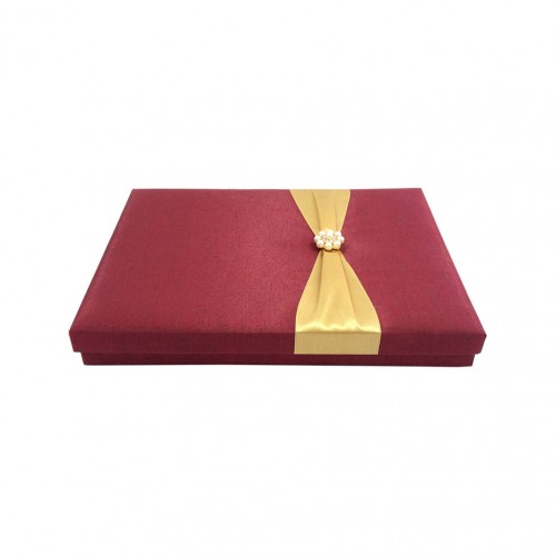 Red silk box with removable lid and gold ribbon bow with pearl brooch