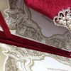 red velvet envelope opened with wedding invitation card