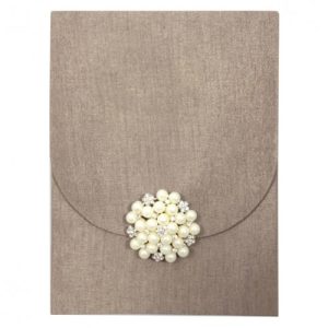 Rust brown silk envelope with large pearl brooch for invitation cards