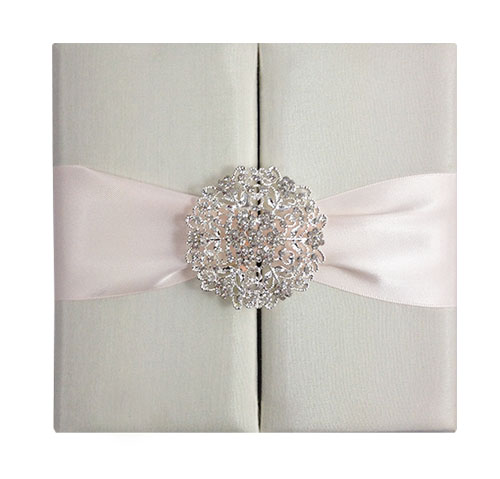Ivory wedding folio with blush pink ribbon and large crystal brooch