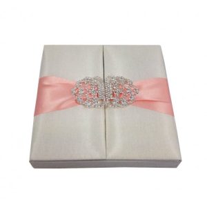 Ivory silk gatefold box with blush pink ribbon and clasp