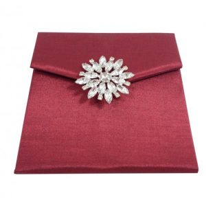Front view of star brooch embellished silk envelope