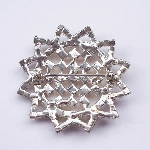 Back of star brooch with stitch pin