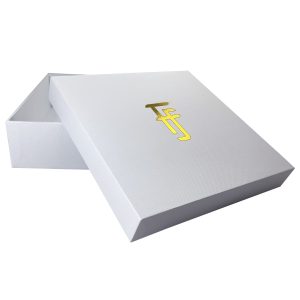 White mailing box with gold foil monogram