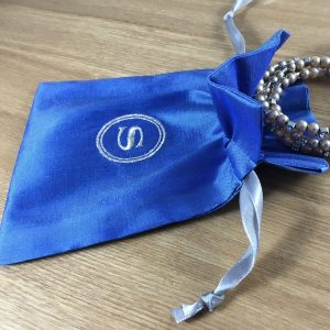 Embroidered blue Thai silk drawstring bag with silver initial embroidery