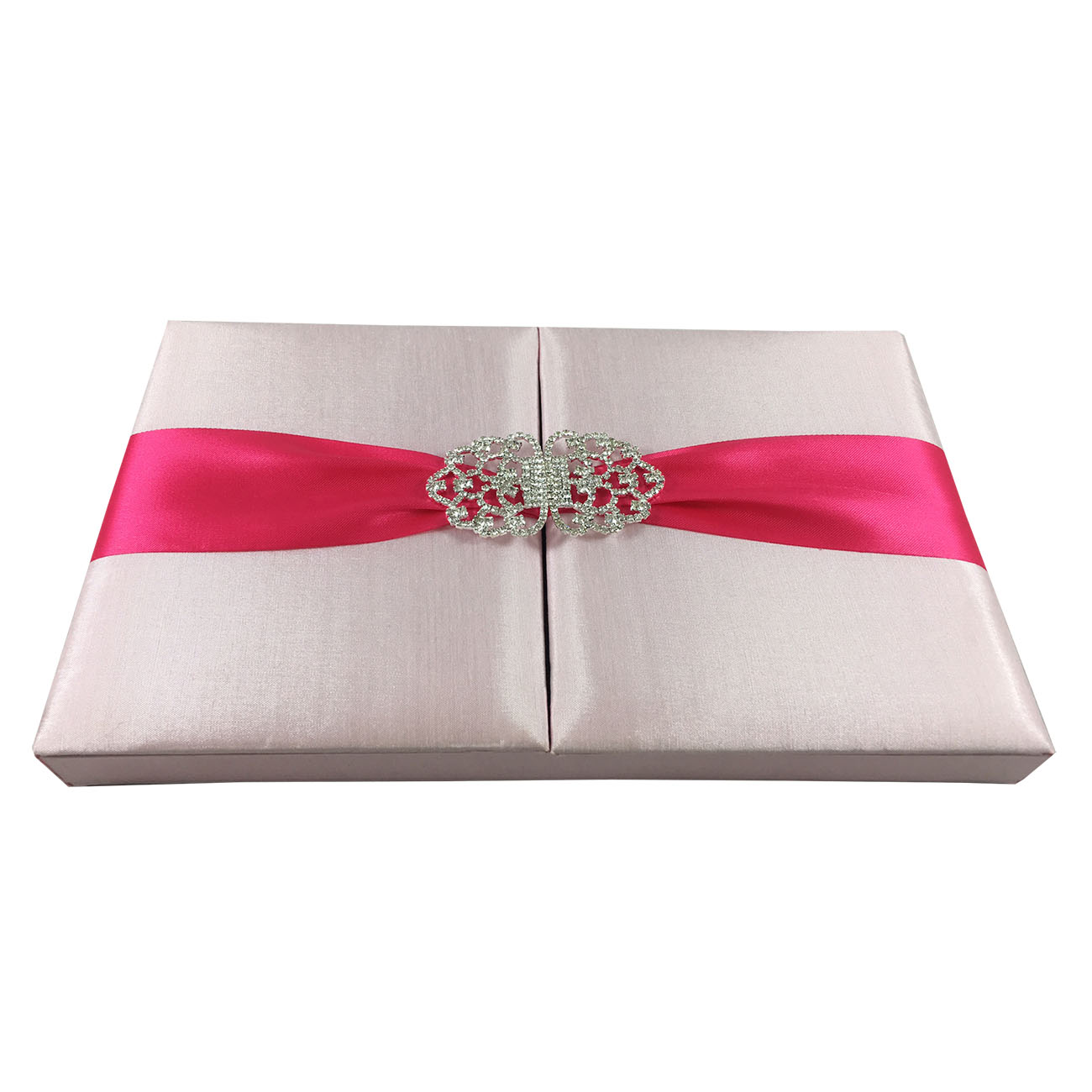 blush pink wedding invitation with diamond brooch