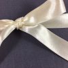 ivory satin bow on linen