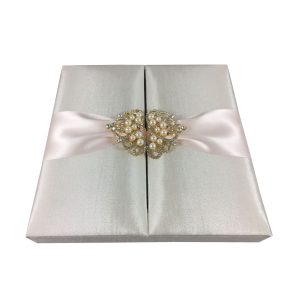 Ivory wedding box with blush ink ribbon and golden crown pearl brooch