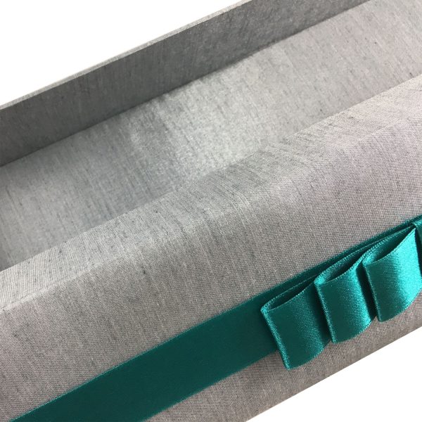 silver silk box with teal ribbon