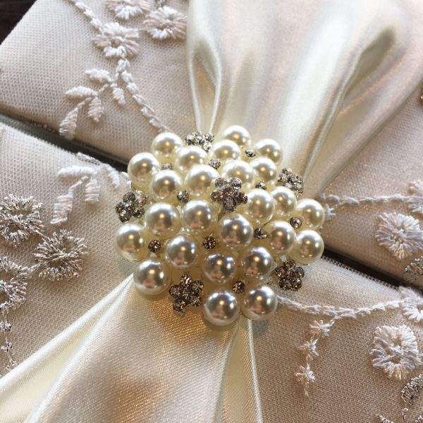 pearl brooch on lace fabric