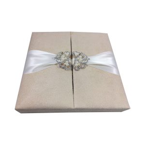 cream suede box with pearl crown brooch embellishment