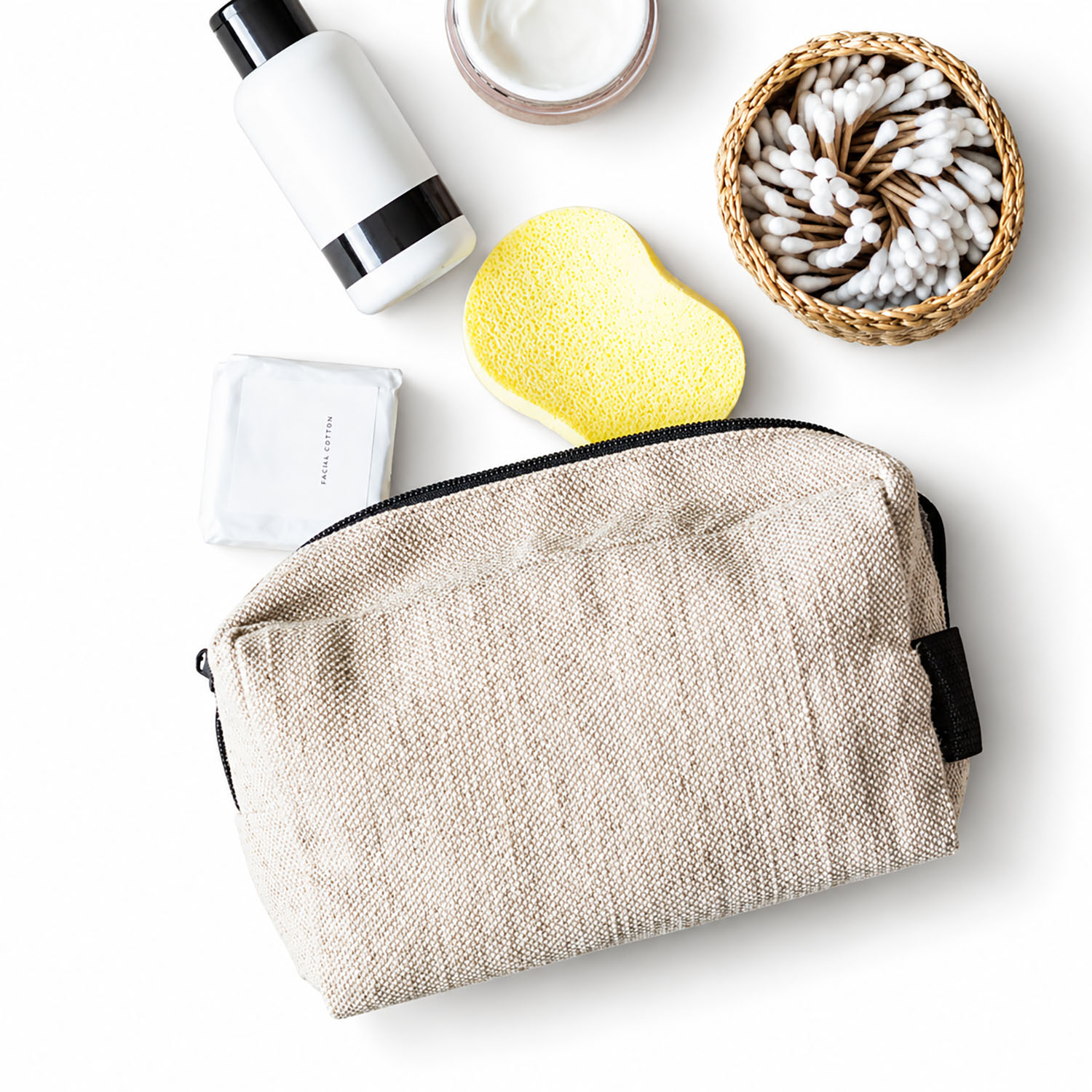 Natural hemp cosmetic bag with black zipper and travel accessories