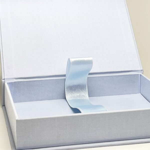 close-up of pale blue linen magnet photo box