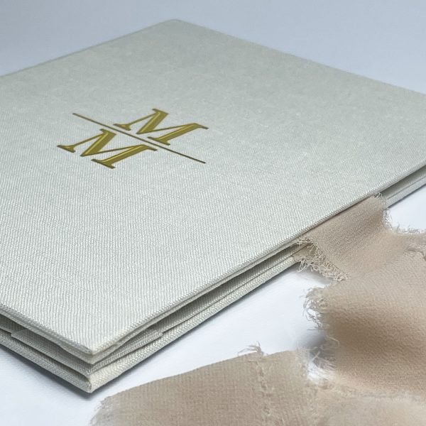 Close-up picture of linen folio with UV initials