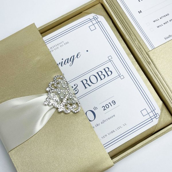 Champagne invitation box with pearl brooch clasp embellishment